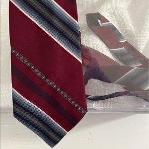 New condition mens vintage striped Ketch necktie in shades of red, blue, black.